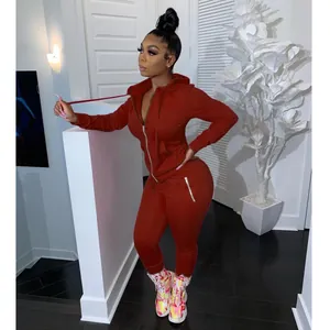 Casual women's two-piece tracksuit in rust red with zip-up hoodie and joggers set