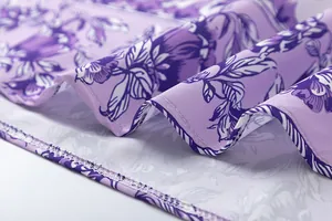 Macro detail of purple floral print fabric and professional hem stitching on dress