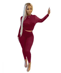 Macro detail of wine red two-piece tracksuit featuring gathered waist corset top