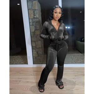 Stylish black velour two-piece tracksuit set with hooded zip-up jacket and wide-leg pants
