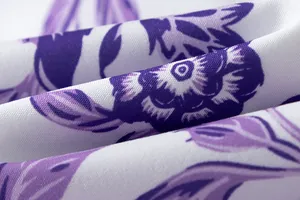 Macro detail of the elegant purple floral print and woven texture on summer dress fabric