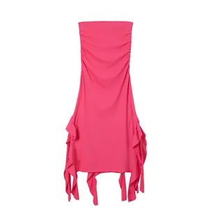 Close-up of hot pink strapless bodycon dress featuring ruffled irregular hem detail