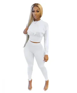 Detail view of women's white two-piece lounge set featuring long-sleeve top and leggings