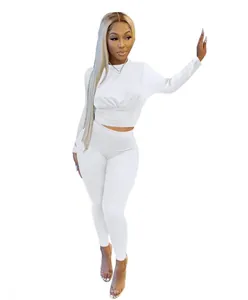 Detailed view of white long-sleeve cinched waist top and matching leggings set