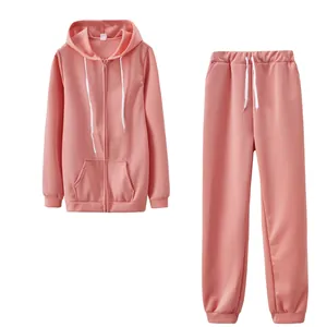 Un ensemble de sport rose deux pièces avec sweat à capuche zippé et jogging