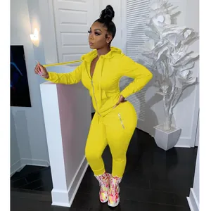 Full view of women's bright yellow two-piece tracksuit set with hoodie and zip pants