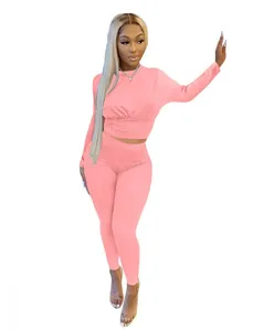 Detailed view of pink long sleeve two-piece set with corset waist and leggings.