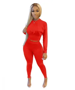 Full view of a red two-piece athletic set with corset-style waist slimming detail.