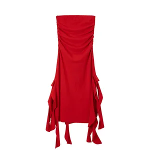Detailed macro view of red strapless ruched bodycon dress featuring irregular hem design