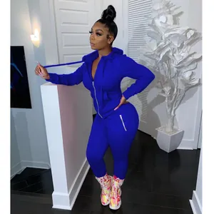 Stylish women's cobalt blue two-piece tracksuit featuring zip-up hoodie and joggers