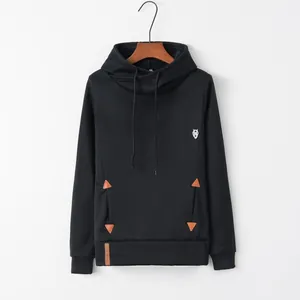 Detailed view of black hooded sweatshirt with owl embroidery and leather pocket accents