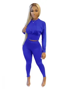 Detail view of blue two-piece sportswear set featuring long-sleeve corset top and leggings