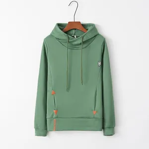 Detailed view of fashionable green long sleeve hoodie with cross-neck hood and pockets.