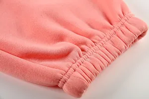 Detail of pink sports casual jumpsuit showing the elasticated ribbed cuff and soft knit fabric
