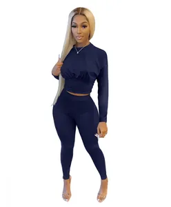 Front view of navy blue two-piece set with long sleeve cinched waist top and leggings