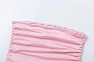 Detail of pink ruched fabric on a strapless bodycon dress with fine stitching.