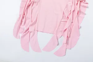 Macro view showing the irregular pink ruffles and soft fabric of this chic dress