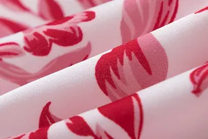 Macro detail of high-quality pink floral print fabric showing twill weave texture