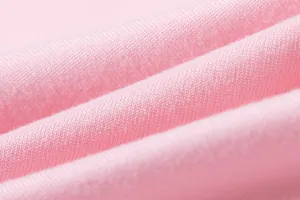 Detailed macro close-up of soft pink knitted fabric texture for fashionable women's dress