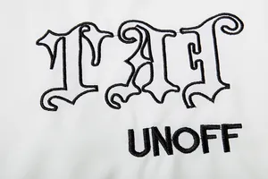 Detailansicht der gotischen Stickerei auf einer weißen Vintage-Streetwear-Kapuzenjacke.