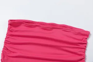 Close-up detail of pink ruched fabric and high-quality stitching on the dress