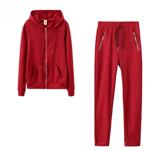 Detailed view of women's red two-piece tracksuit with hoodie and matching pants