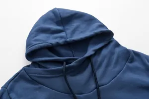 Close-up detail showing the hood and collar construction of a navy blue drawstring hoodie