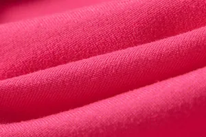 Close-up detail of soft fuchsia knitted fabric texture for a stylish women's dress