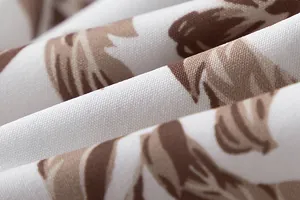 Close-up macro shot of the elegant floral tie-dye print fabric showing clear weave texture