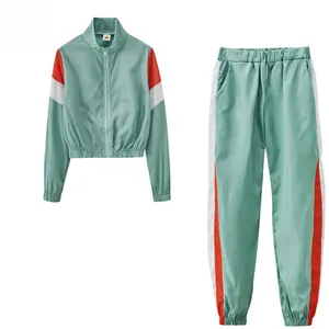 Ensemble de survêtement sport deux pièces pour femme avec bandes latérales orange et blanc