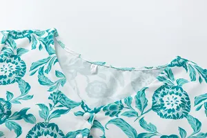 Detailed close-up view of a floral print summer dress neckline with V-neck and size label