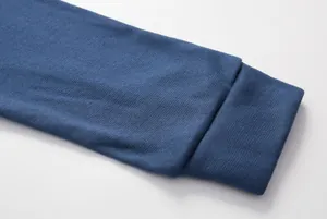 Close-up detail of a navy blue long sleeve hoodie showing ribbed knit cuff texture