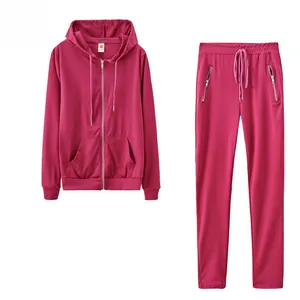 Detailed view of the pink two-piece tracksuit with zip-up hoodie and pocketed pants.