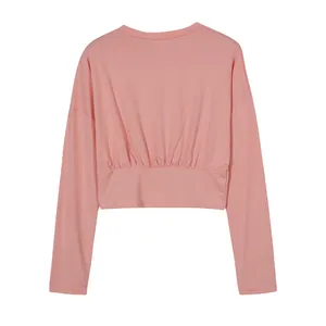 Detailed back view of a pink long sleeve athletic crop top with a cinched waist design