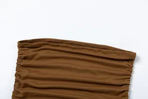 Detailed close-up of brown ruched fabric on a slim off-the-shoulder tube top dress