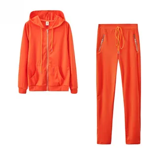Women's sporty orange two-piece tracksuit featuring zip-up hoodie and drawstring pants