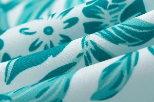 Close-up detail of the breathable floral printed fabric with turquoise leaf pattern