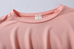 Close-up view of pink round neckline and size S label on women's casual sports clothing