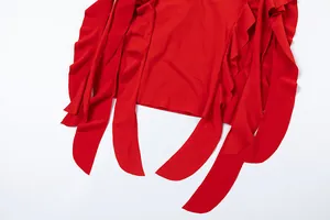 Detailed view of vibrant red irregular hem and ruffle elements on a stylish bodycon dress
