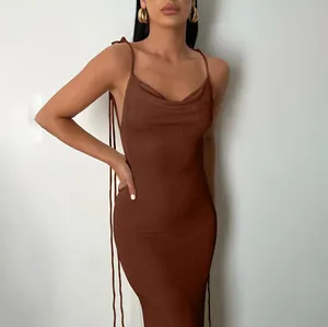Close-up of elegant brown cowl neck maxi dress with tie-up straps and open back detail