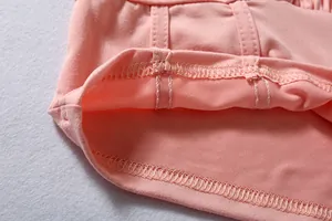 Close-up detail showing the high-quality stitching and soft pink fabric of this sports set.