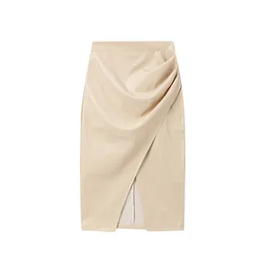 Detailed view of a stylish beige high-waisted PU leather midi skirt featuring ruched slit