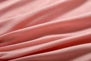 Detailed close-up showing the soft texture and weave of pink knit fabric material