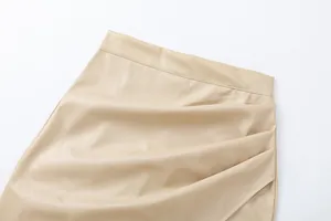 Detailed macro view showing the elegant pleated design and PU leather texture of this beige skirt