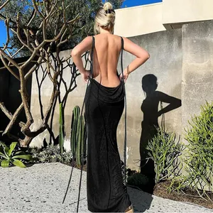 Back view of a sexy blackless black maxi dress featuring elegant long tie straps detail
