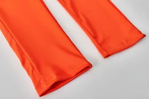 Detailed view of the double-stitched sleeve cuffs on vibrant orange sports tracksuit
