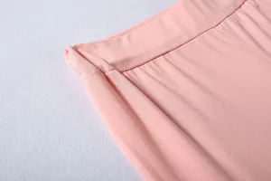 Detail view showing the elastic waistband and smooth pink fabric of a women sports set