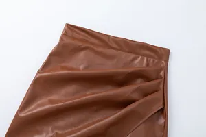 Detailed close-up showing the pleated texture and high-waisted design of brown PU skirt