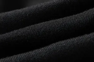 Macro view of high-quality black knitted fabric texture for women's slim dress detail