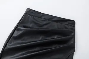 Close-up detail showing the ruched texture and high waist of a black PU leather skirt